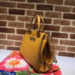 Gucci-Zumi-grainy-leather-medium-top-handle-bag-yellow.png